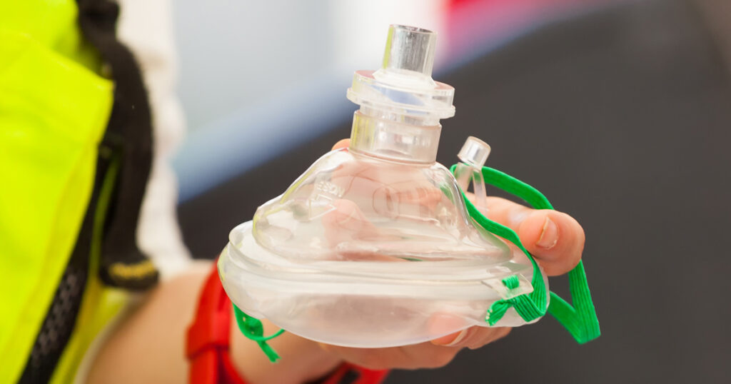 CPR Training Instructor holding PR Mask